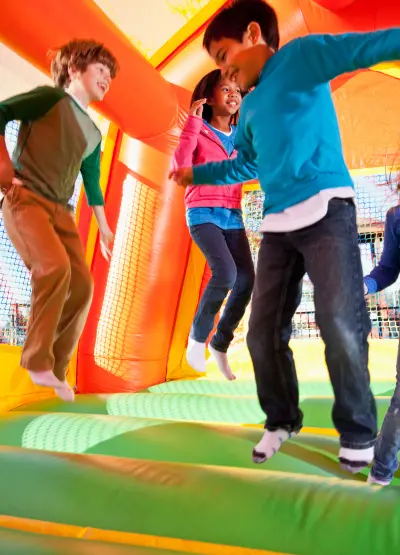 Children Playing in a Bouncy House Wearing UltraGrip Anti-Slip Socks - Safe and Fun Non-Slip Socks for Active Play