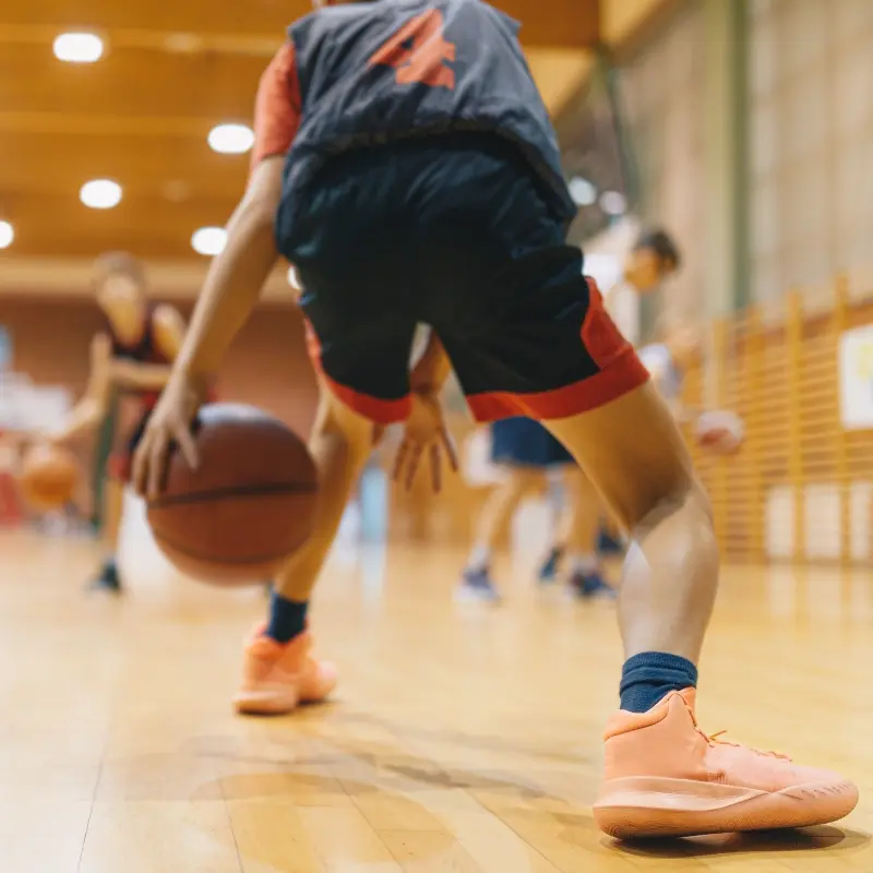 Basketball player in action wearing grip socks for enhanced stability and performance on the court.