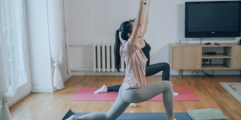 Person practicing yoga wearing grip socks for better balance and safety.